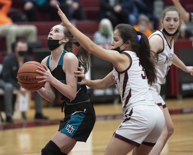 Woodstock North's Lacey Schaffter looks to shoot as Marengo's Keatyn Velasquez defends during their game on Tuesday, February 1, 2022 at Marengo High School. Woodstock North won 46-42.