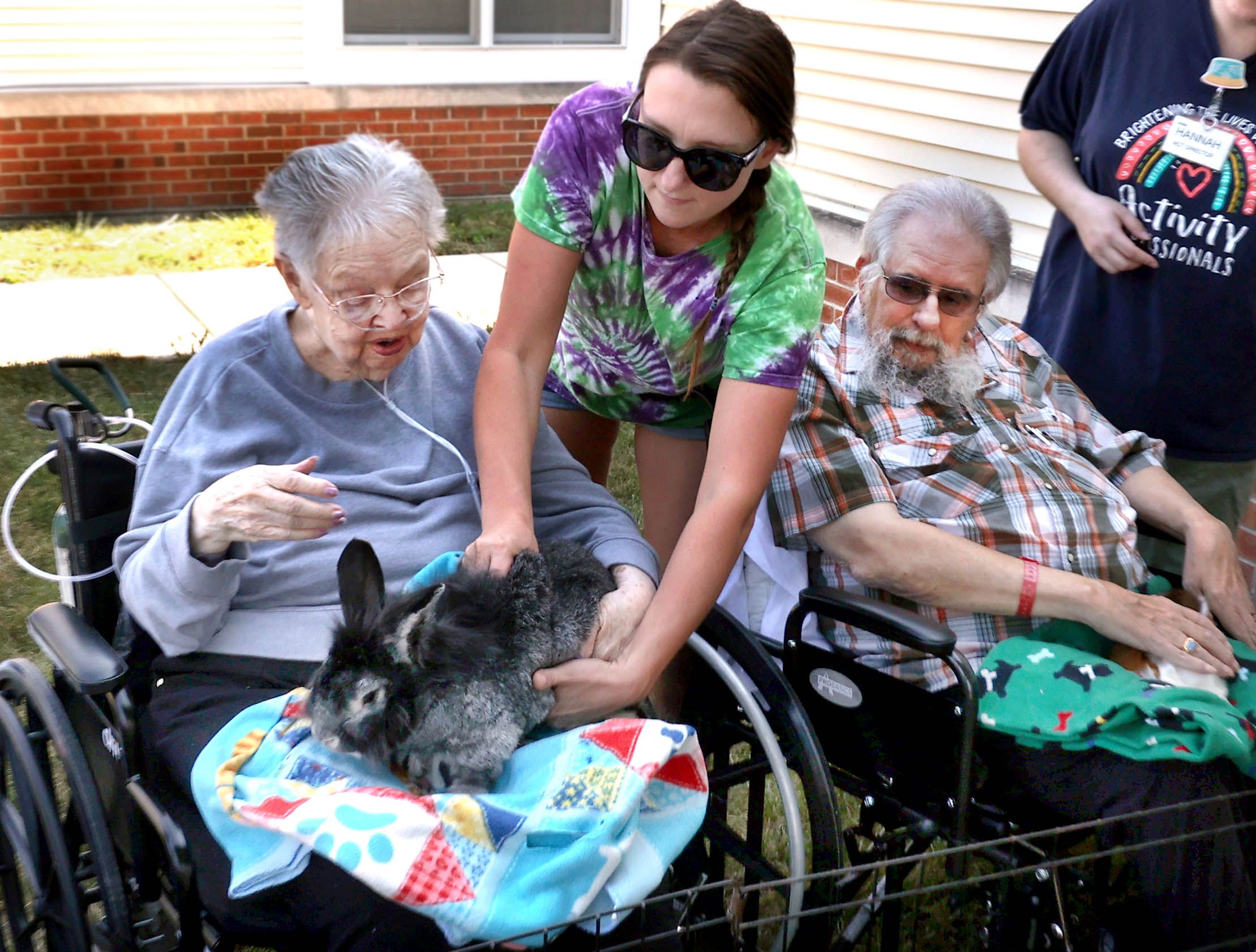 Katie Ford, from Kate’s Kritters Mobile Petting Zoo brings a rabbit to DeKalb County Rehab and Nursing Center resident Jessie Lavender during a petting zoo Thursday, Sept. 18, 2025, at the facility in DeKalb.