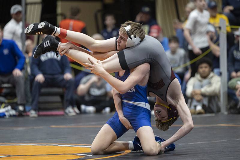 Newman’s Tyler Grennan flips Rockridge’s Nate Lower in the 106 pound 3rd place match Saturday, Feb. 14, 2026, during the Class 1A wrestling sectionals in Byron.