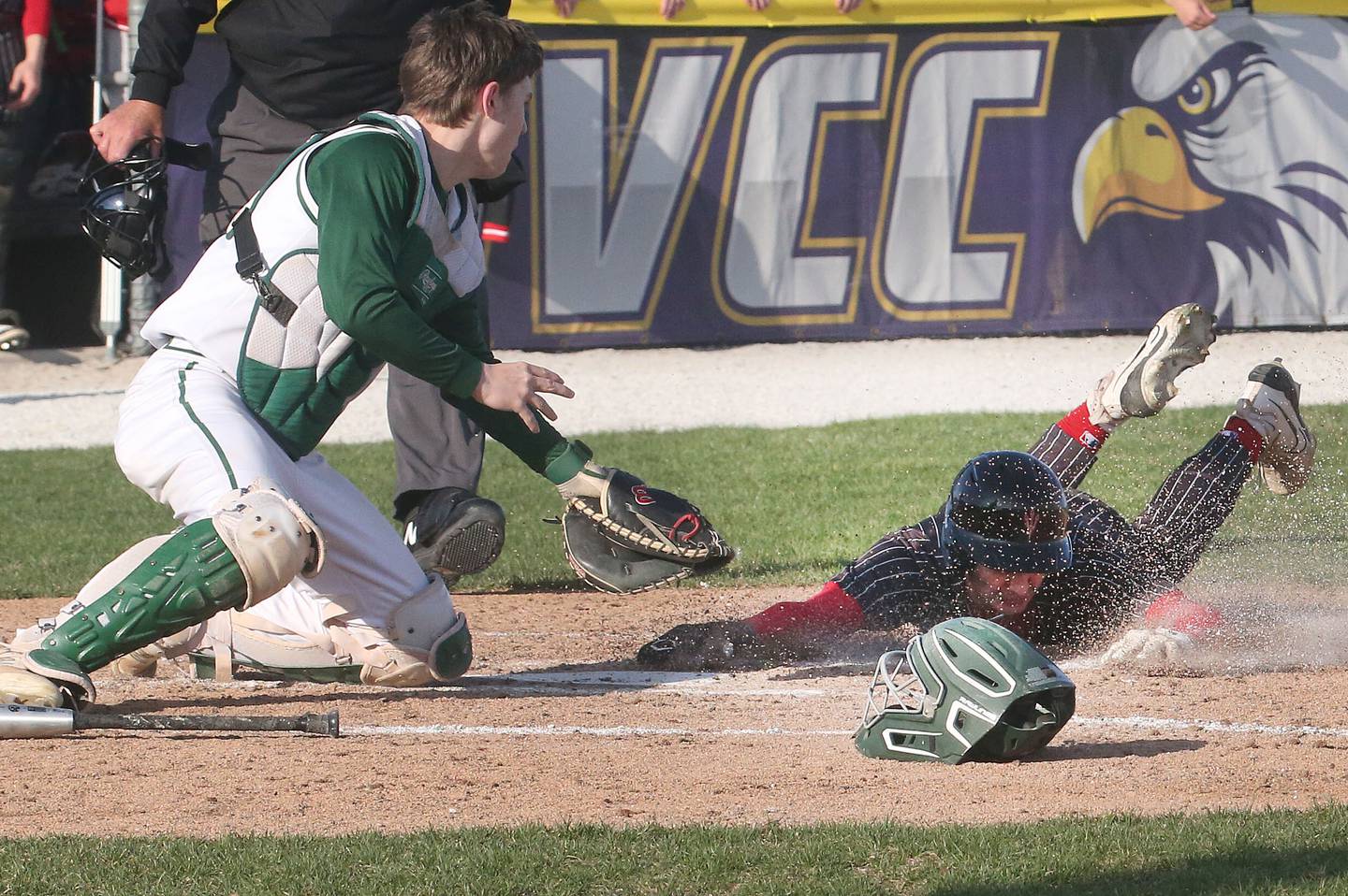 Hall's Jack Jablonski beats the tag from St. Bede catcher Carson Riva at the plate as he is called safe on Monday, March 31, 2025 at Schweickert Stadium in Peru.