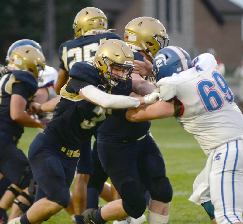 Polo's Damon Rowe (3) blocks a Bushnell-Prairie City player during 8-man action on Friday, Aug, 29, 2025 in Polo.