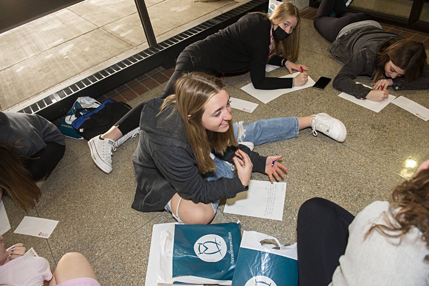 Amboy's Hailey Stenzel speaks with her classmates Friday during an education symposium at Sauk Valley Community College. The group was tasked to write a letter to an influential teacher.