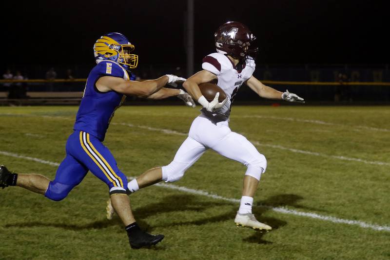 Marengo’s Alten Bergbreiter breaks away from Johnsburg's Conor Benz as her returns the opening kickoff for a touchdown during a Kishwaukee River Conference football game on Friday, Sept. 15, 2023, at Johnsburg High School.
