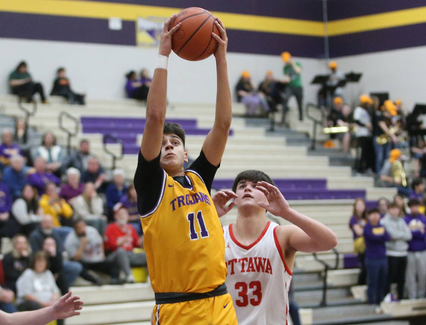 Mendota's Izaiah Nenez grabs a rebound over Ottawa's Cooper Knoll on Tuesday, Feb. 13, 2024 at Mendota High School.