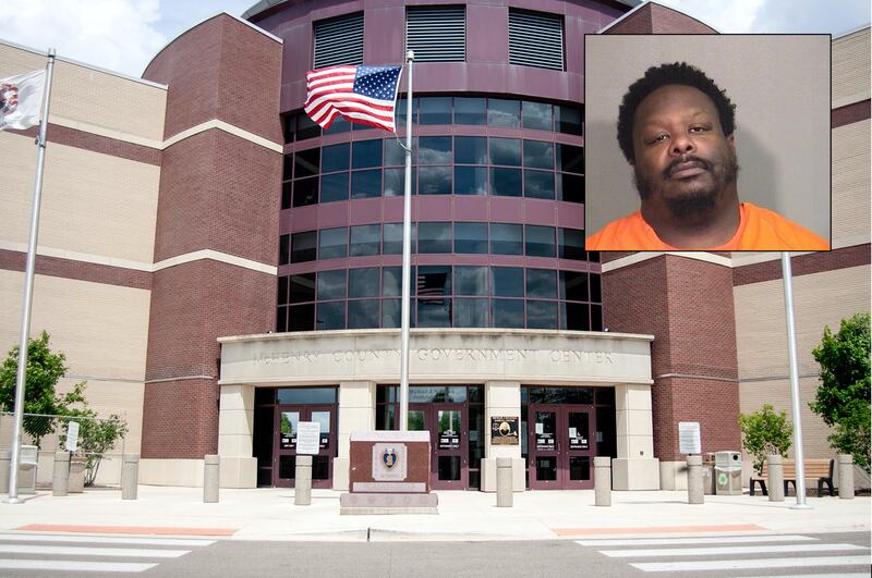 Eric A. Williams in front of a Northwest Herald file photo of the McHenry County courthouse.