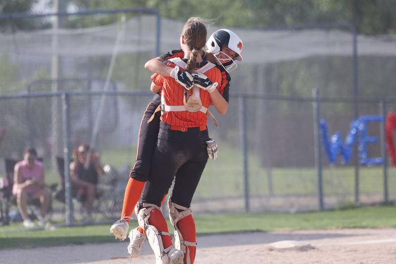 Minooka’s Payton Psinas gets lifted by Gracie Anderson after her two run double ended the game on the 10 run rule against Normal in the Class 4A sectional semifinal on Tuesday, May 21, 2024 in Minooka.