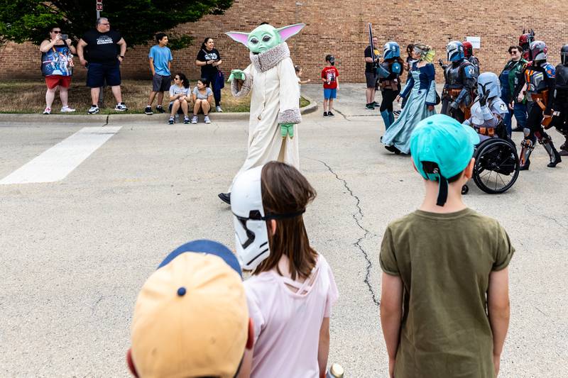 Grogu (Baby Yoda) waves to attendees during Joliet Public Library's Star Wars Day event on June 7, 2025.
