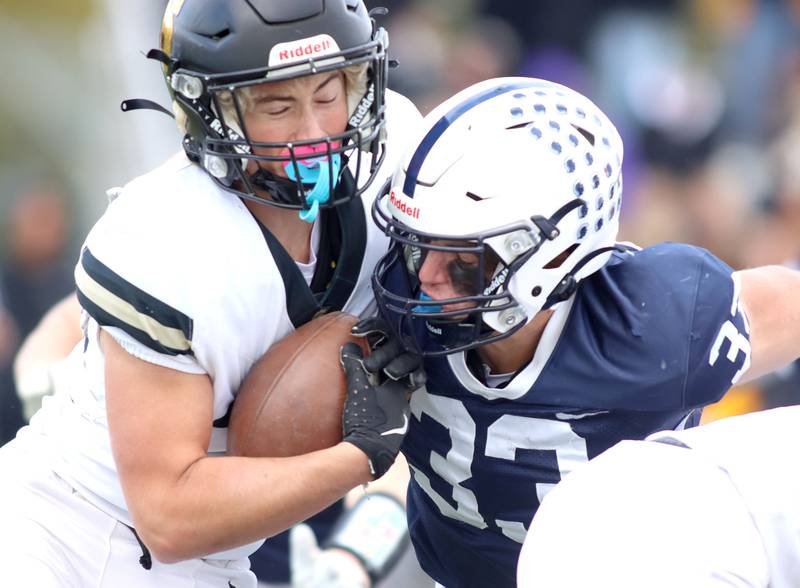 Cary-Grove’s Oliver Antonelli, right, hits Sycamore’s Liam Arhos in IHSA football Class 5A first-round playoff action at Al Bohrer Field on the campus of Cary-Grove High School in Cary on Saturday, November 1, 2025.