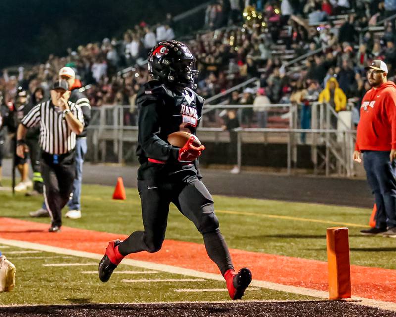 Glenbard East's Donte Hudson (5) runs in a touchdown during football game between Glenbard South at Glenbard East.   Oct 13, 2023.