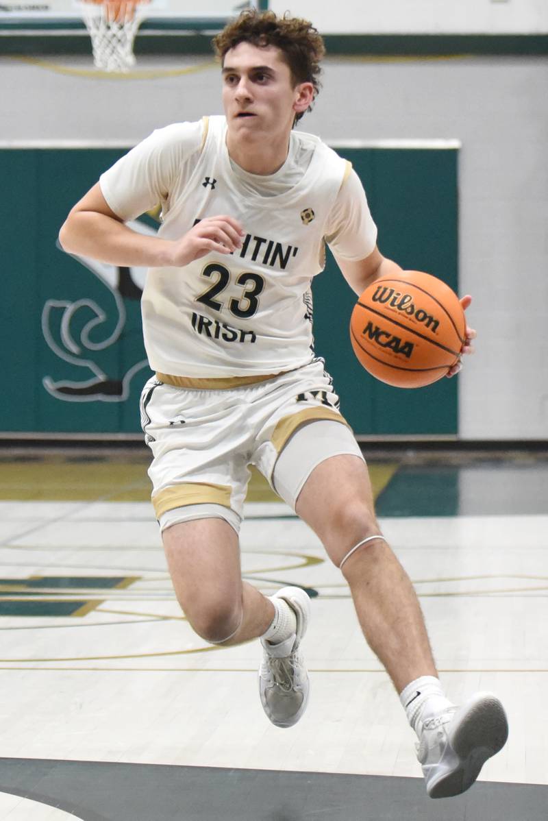 Bishop McNamara's Karter Krutsinger drives to the basket during a home game against Lycee Francais de Chicago Wednesday, Feb. 18, 2026.