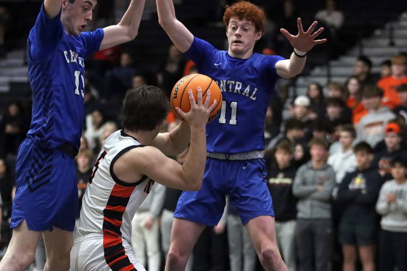 Burlington Central’s Patrick Magan, left, and Patrick Shell, right, swarm McHenry’s Kyle Maness in varsity boys basketball on Tuesday, Feb. 4, 2025, at  McHenry High School  in McHenry.