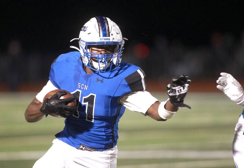 St. Charles North’s Joell Holloman runs the ball during a game against Geneva in St. Charles on Friday, Oct. 20, 2023.
