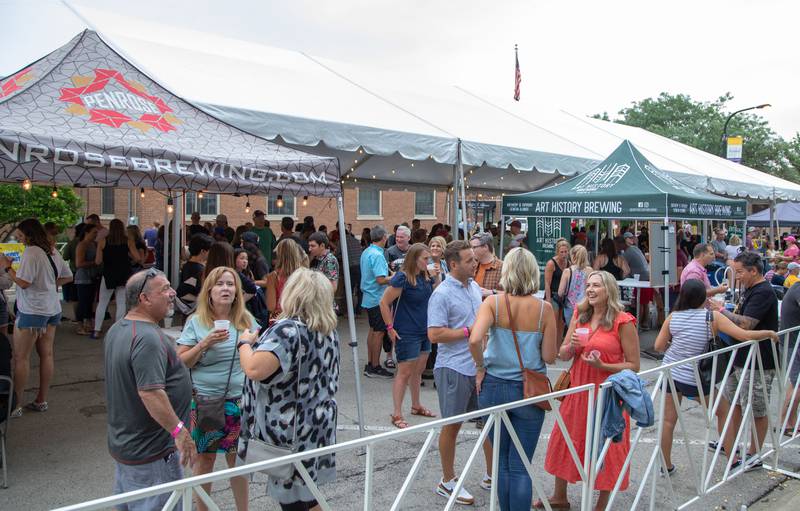 Patrons enjoy drinks at the craft beer tent at Swedish days on Saturday, June 25, 2022.