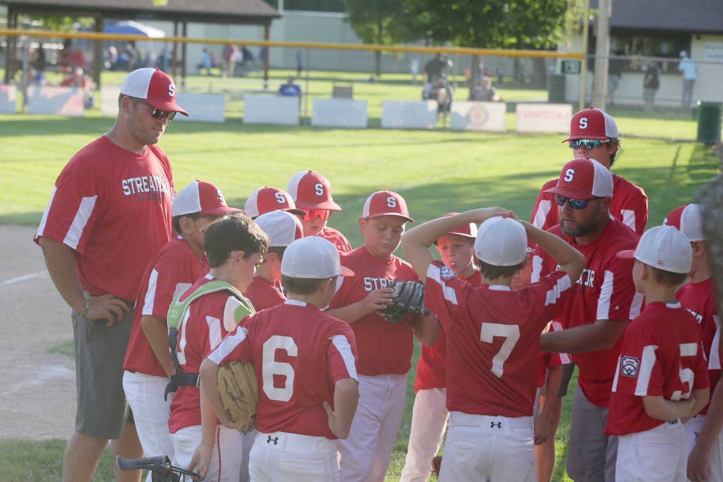 Members of the 10-Year-Old Streator All-Stars meet in between innings of he District 20 Little League championship game on Wednesday, July 13, 2022, at Jim Bottomley Field in Oglesby.