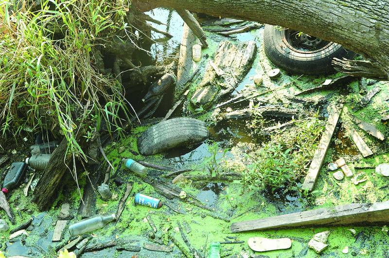 Tires and other trash items float in the Rock River above the Oregon dam. The Ogle County Solid Waste Management Department will collect used tires in April. The collection event is for Ogle County residents only.