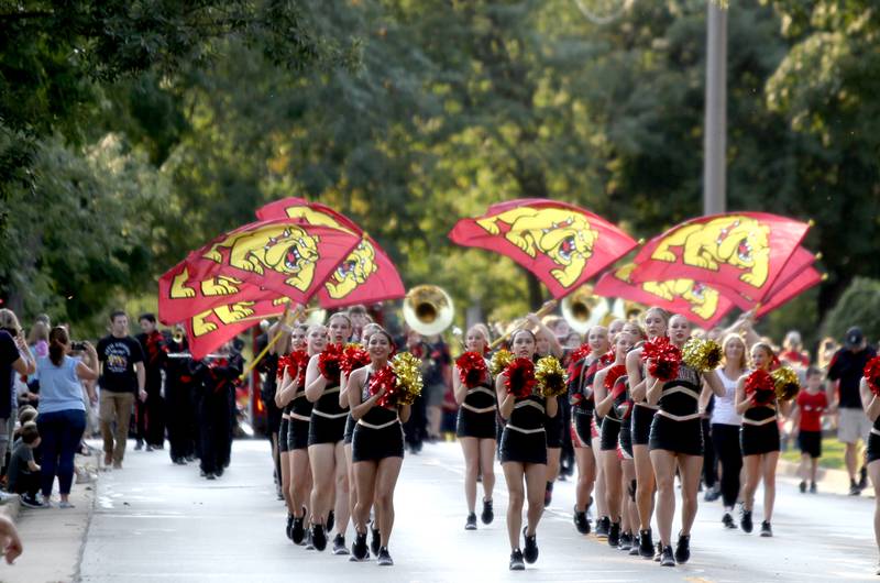 The dance and flag teams lead the marching band at the start of the Batavia High School Homecoming parade on Wilson Street on Wednesday, Sept. 14, 2022.