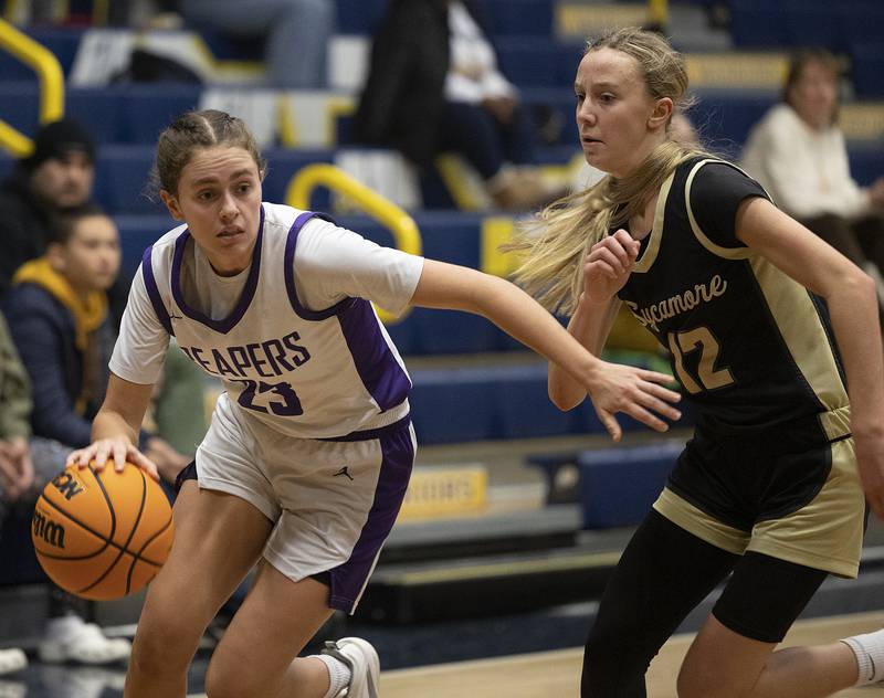 Plano’s Josie Larson drives against Sycamore’s Sadie Lang Monday, Feb. 17, 2025, during a 3A semifinal in Sterling.