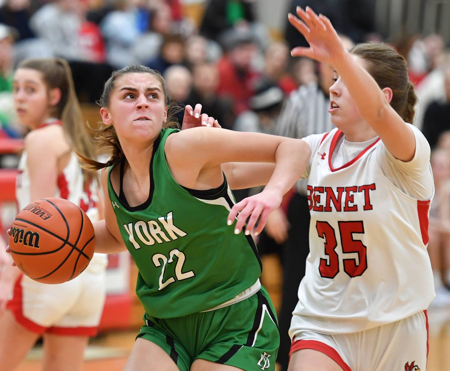 York's Stella Kohl (22) drives to the hoop as Benet's Emilia Sularski (35) defends during a game on Dec. 20, 2022 at Benet Academy in Lisle.