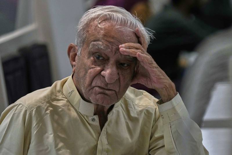 A dejected investor waits to restart trading, suspended for an hour following a 5% drop in in its main index at the Pakistan Stock Exchange (PSE), in Karachi, Pakistan, Monday, April 7, 2025. (AP Photo/Fareed Khan)