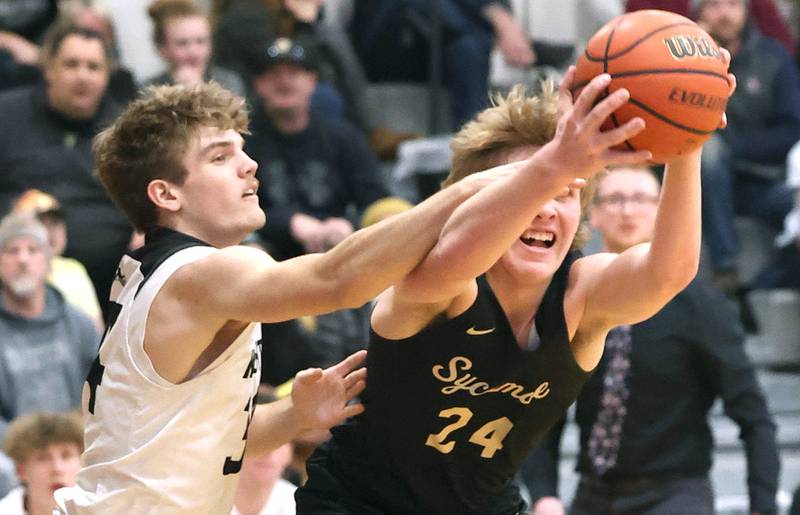 Sycamore's Lucas Winburn and Kaneland's Parker Violett go after a rebound during their Class 3A regional semifinal game Thursday, Feb. 23, 2023, at Kaneland High School.