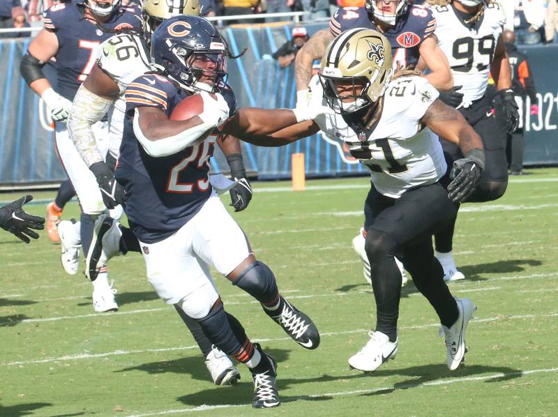 Chicago Bears running back Kyle Monangai stiff arms New Orleans Saints safety Justin Reid on Sunday, Oct .11, 2025 at Soldier Field in Chicago.