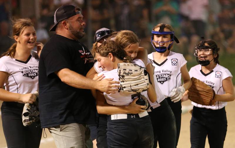 Spring Valley head softball coach Josh Pellegrini, and his team celebrate on the mound after defeating Evergreen Park 5-1 in the Minor League Softball State title game on Thursday, July 27, 2023 at St. Mary's Park in La Salle.