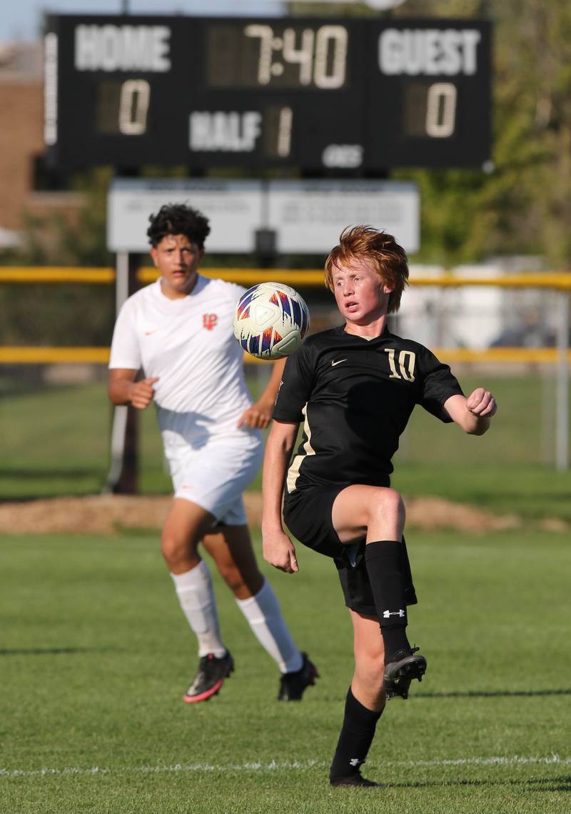 Sycamore's Jameson Carl knocks down the ball in front of La Salle-Peru's Marco Zamudio during their game Wednesday, Sept. 7, 2022, at Sycamore High School.