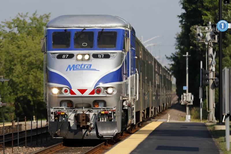 Metra commuters arrive on the platform from Chicago at Fox River Grove on Tuesday, July 6, 2021.