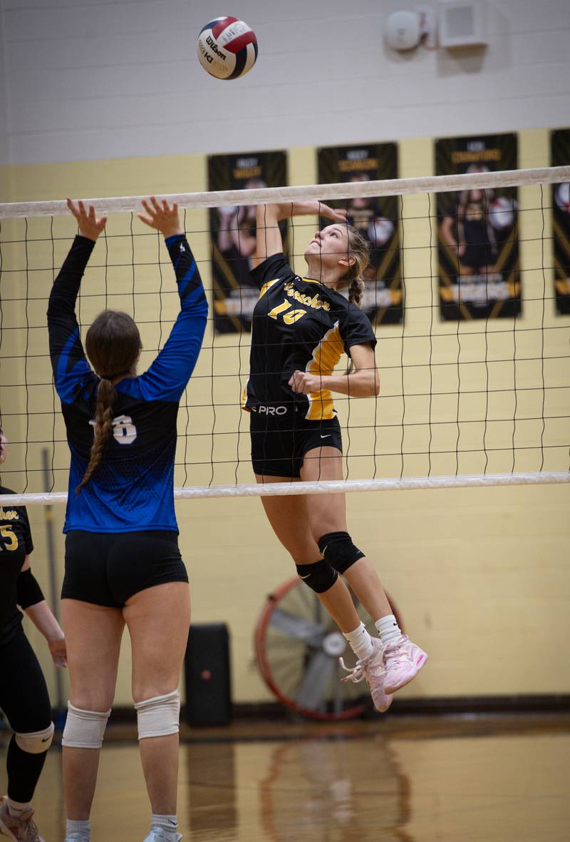 Herscher's Lexi Crawford elevates to make a hit as Clifton Central's Maddie Webb, left, defends in a match on Monday, September 29, 2025.