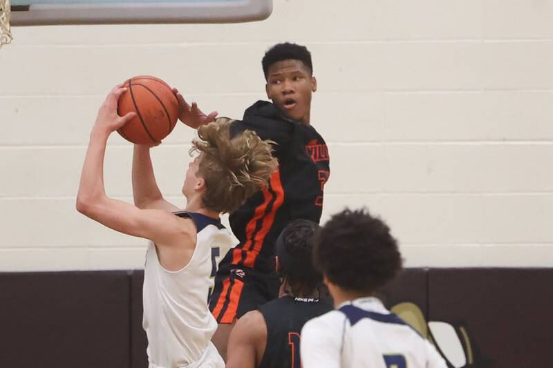 Romeoville’s Kaharie Loggin blocks a shot by Lemont’s Rokas Castillo in the WJOL Thanksgiving Classic Championship in Joliet on Saturday.