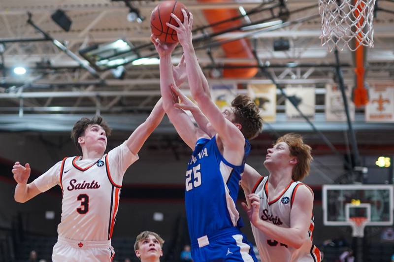 Geneva’s Hudson Kirby (25) rebounds the ball against St. Charles East's Marco Klebosits (3) and Bradley Monkemeyer (32) during a basketball game at St. Charles East High School on Friday, Feb 9, 2024.