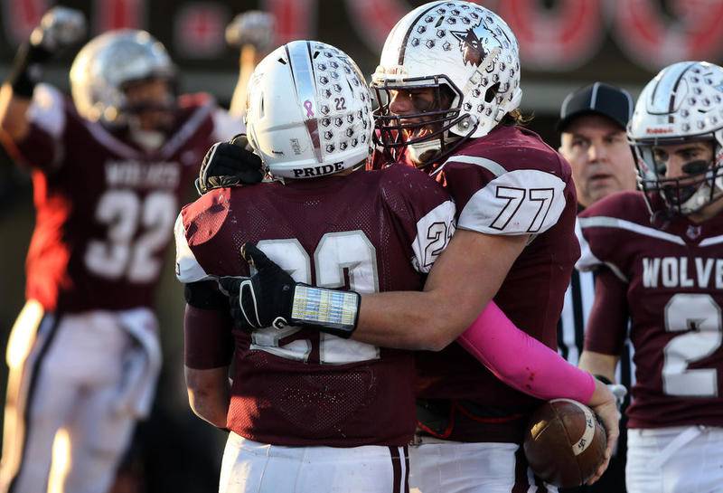 Prairie Ridge's Jeffrey Jenkins (77) hugs Samson Evans as the Wolves celebrate what would become the winning touchdown during their 2017 IHSA state championship 6A football game on Saturday, Nov. 25, 2017 at Huskie Stadium on the campus of Northern Illinois University in DeKalb.