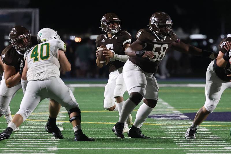 Joliet Catholic’s Andres Munoz drops back to pass against Providence on Friday, Sept. 1, 2023 Joliet Memorial Stadium.