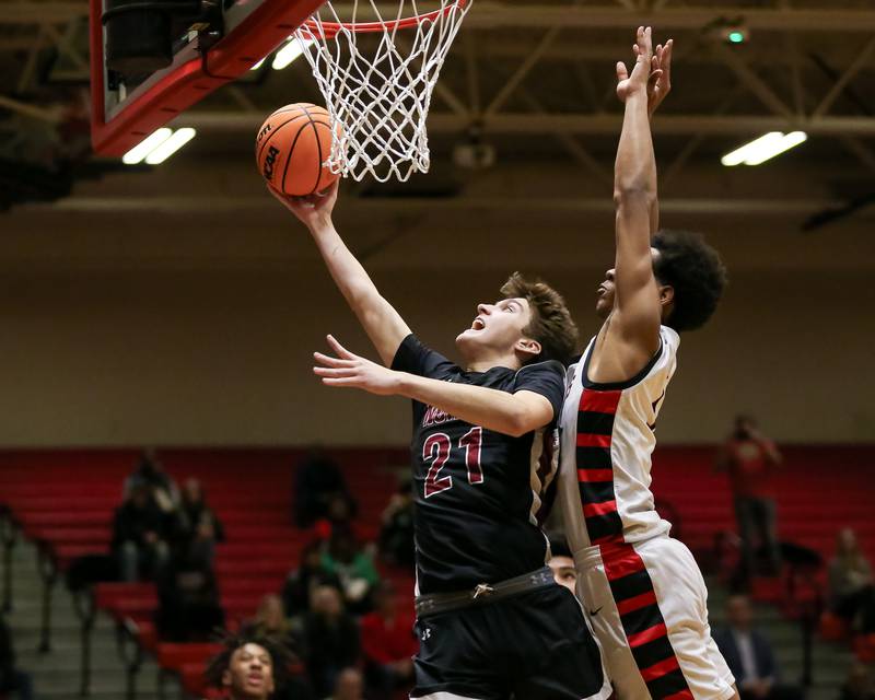 Plainfield North's Joseph Charbonneau (21) goes up for a layup during their basketball game between Plainfield North at Bolingbrook, Friday Dec 13, 2024 in Bolingbrook.