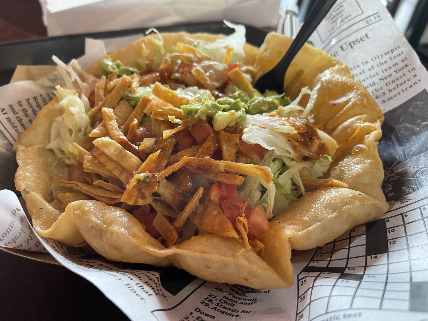 The chicken taco bowl, topped off with some salsa and guacamole.