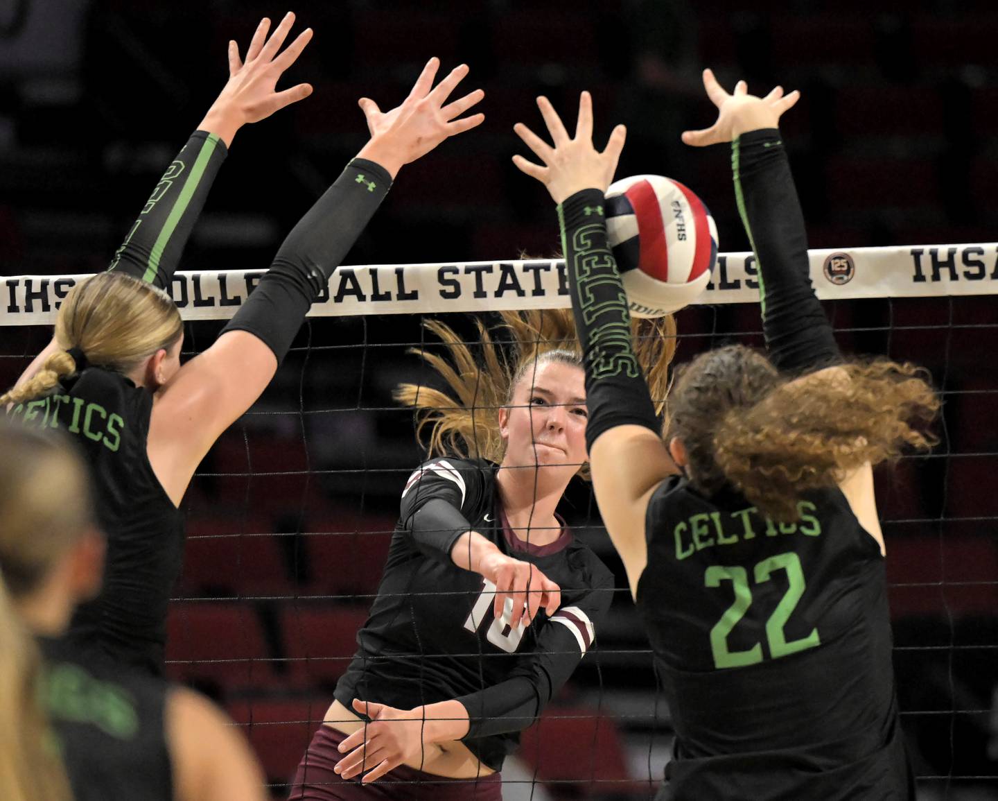 Prairie Ridge’s Adeline Grider shoots toward Providence Catholic’s Abbey Knight and Grace Lustig, right, in the Class 3A third place match at the IHSA girls volleyball state finals tournament on at Illinois State University on Saturday, Nov. 15, 2025