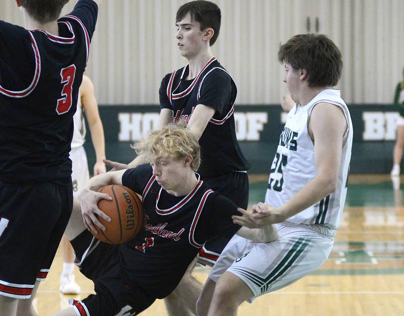 Woodland’s Connor Dodge is knocked down after grabbing a rebound during the 2nd period of the Class 1A Regional game on Saturday, Feb. 18, 2023 at St Bede.