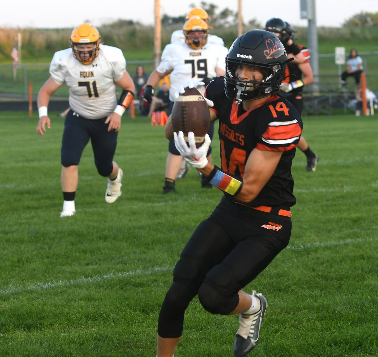 Milledgeville's Kacen Johnson squeezes a pass for a completion against Freeport Aquin.