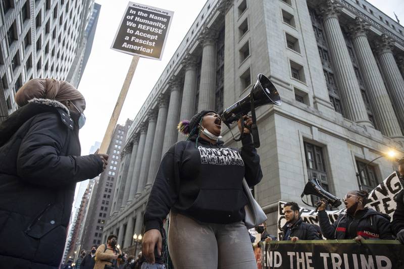 An activist chants in front of City Hall in the Loop to protest the acquittal of Kyle Rittenhouse, Saturday afternoon, Nov. 20, 2021, in Chicago. Rittenhouse was acquitted of all charges Friday after testifying he acted in self-defense in the deadly Kenosha shootings that became a flashpoint in the debate over guns, vigilantism and racial injustice in the U.S. (Pat Nabong/Chicago Sun-Times via AP)
