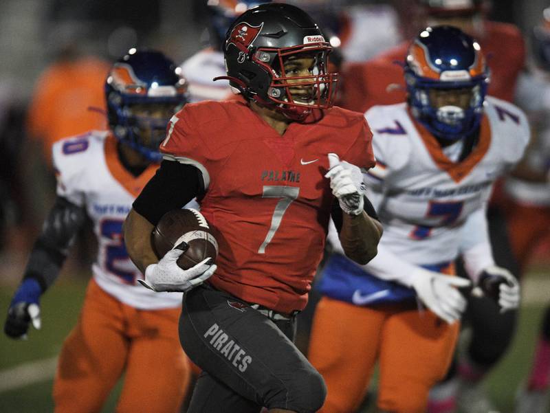 Palatine's Dominik Ball runs against Hoffman Estates in a football game in Palatine on Friday, October 22, 2021.