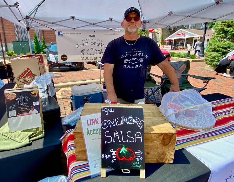 Dale Luker of One More Salsa – MKD Speciality, Inc. poses at his stand during the opening day of the DeKalb farmers market on Thursday, June 5, 2025, in Van Buer Plaza in downtown DeKalb. The market opened its 30th year Thursday.