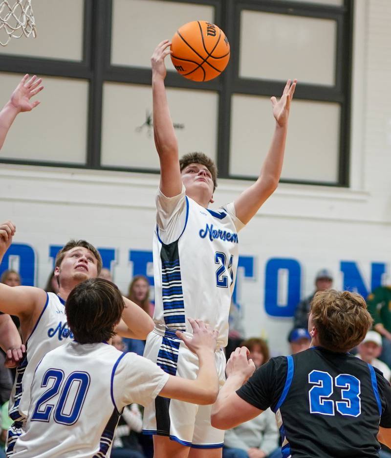 Newark’s Jimmy Kath (21) rebounds the ball late in the 4th quarter against Hinckley-Big Rock during a basketball game at Newark High School on Tuesday, January 28, 2025.