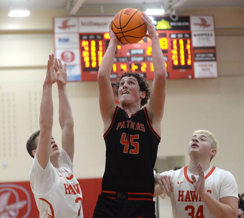 Erie-Prophetstown's Gus Schultz (45) shoots while Oregon's Tucker O'Brien (left) and Kade Girton (right) defend during 2A regional action on Monday, Feb. 24, 2025 at the Blackhawk Center in Oregon.