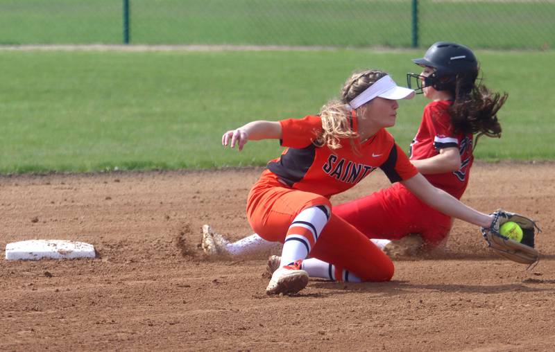 St. Charles East’s Abby Arendts fields the throw as Huntley’s Katie Mitchell slides safely at second base during varsity softball at Marengo Saturday morning.