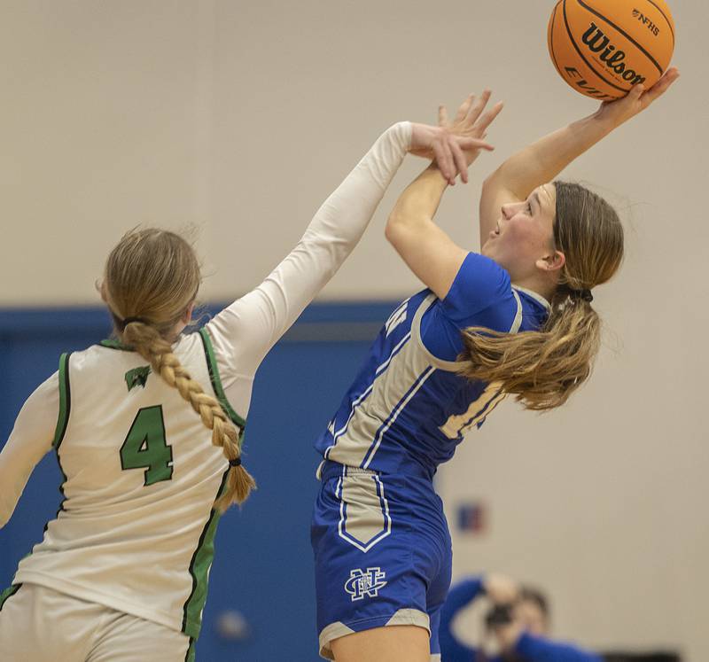 Newman’s Elaina Allen puts up a shot against Wethersfield’s Abbey Carman Thursday, Feb. 26, 2026, in the Class 1A sectional semifinal at Eastland.
