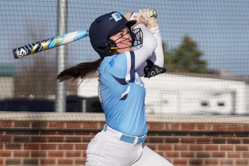 Downers Grove South's Addison Yurchak (11) hits a two run triple during a softball game against Oswego at Oswego High School on Tuesday, March 19, 2024.