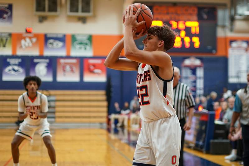 Oswego’s Luke Roller (22) shoots a three pointer  against Rockford Guilford during a hoops for healing basketball tournament game at Oswego on Monday, Nov. 25, 2024.