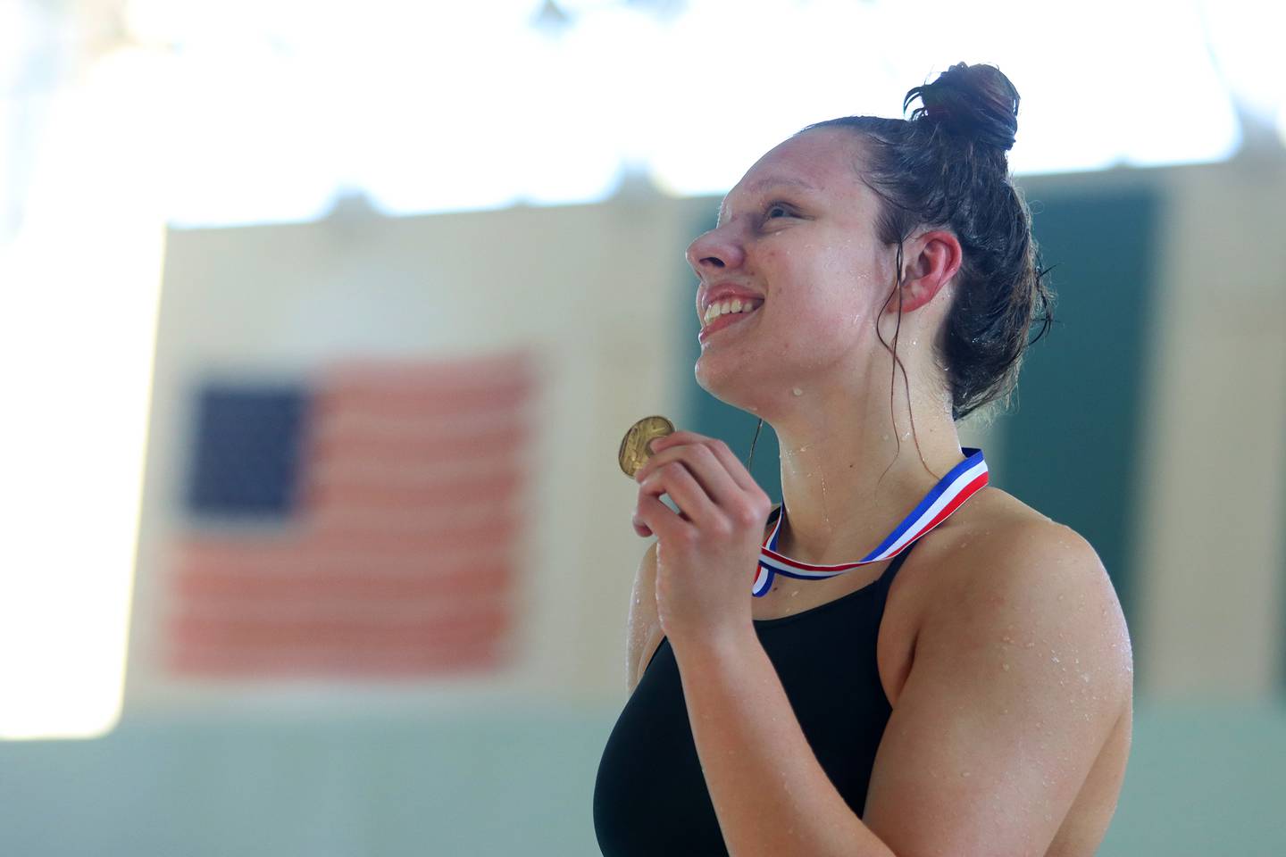 Bella Fontana of Crystal Lake South co-op displays her first place medal after the 200-yard freestyle during the Fox Valley Conference Championship Meet at Woodstock North High School on Saturday, Nov. 2, 2024 in Woodstock .