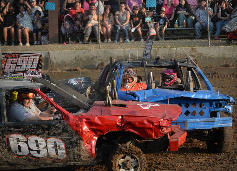 Aubree Boss, 12, and her dad Brick (blue car) crash into Abby Boss, 17, of Rock Falls, and her passenger, Travis,  during the Young Gun heat at the Ogle County Fair's demolition derby on Saturday, Aug. 2, 2025.
