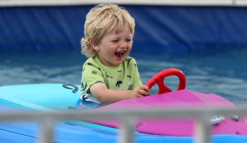 Cayden Eder, 3, of Harvard, enjoys a spin on bumper boats Saturday, July 2, 2022, during the Red, White and Blue Food Truck FEASTival at Milky Way Park in Harvard.